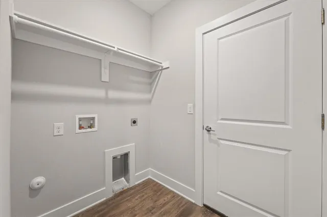 a view of a kitchen with a sink and wooden floor