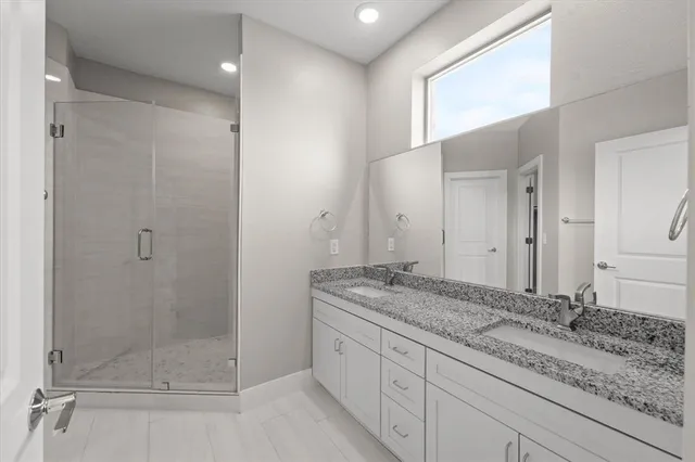 an empty room with windows and cabinet