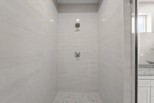 an empty room with fan and entrance