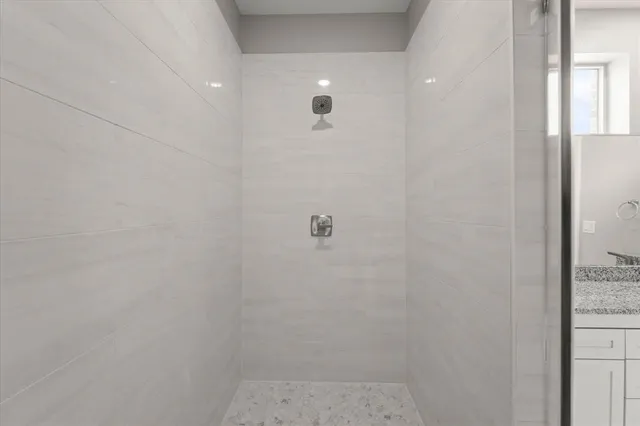 an empty room with fan and entrance