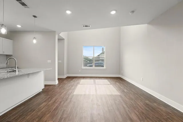 a kitchen with stainless steel appliances granite countertop a sink and wooden cabinets