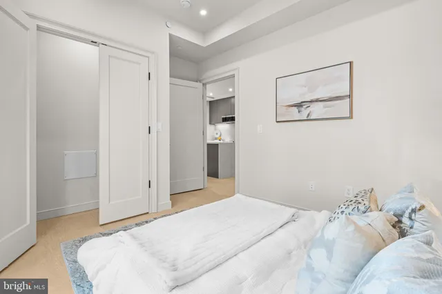 a bedroom with a bed and the view of bathroom