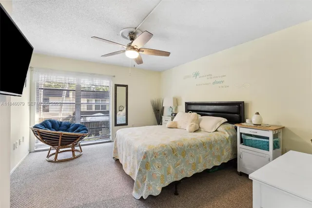 a view of a roof deck with table and chairs under an umbrella