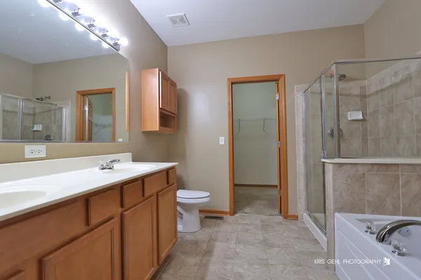 a bathroom with a sink and mirror with toilet