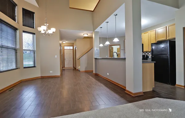 a view of a kitchen with a refrigerator and a window