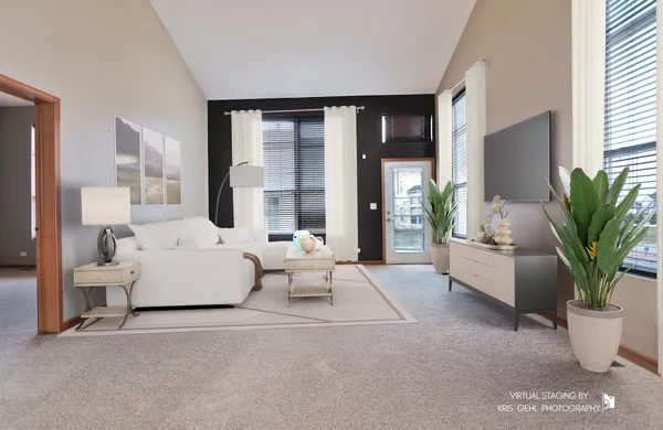 a living room with furniture and large windows