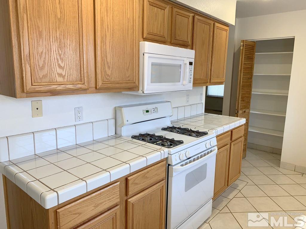 14400 Ghost Rider Drive Reno, NV 89511 - Photo 6 of 17 a kitchen with a stove and a microwave