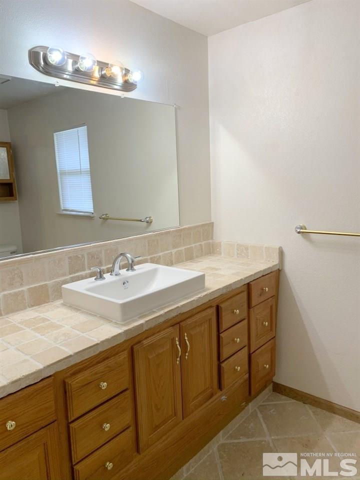 14400 Ghost Rider Drive Reno, NV 89511 - Photo 9 of 17 a bathroom with a sink and a mirror