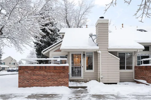 a view of a white house with large windows