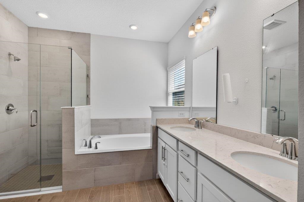 210 White Rabbit Run St. Augustine, FL 32092 - Photo 14 of 85 a bathroom with a tub sink and mirror