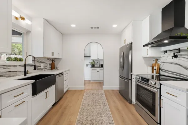 a kitchen with a sink stove and refrigerator
