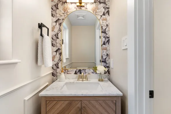 a bathroom with a sink a mirror and a shower