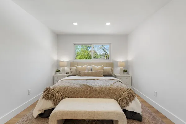 a bed room with a bed and a window