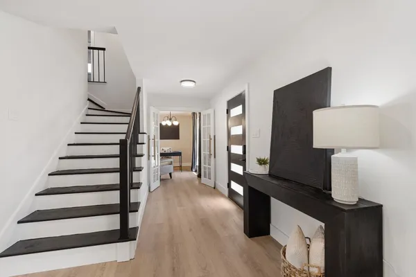 a view of entryway and hall with wooden floor
