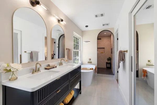 a spacious bathroom with a double vanity sink and a mirror