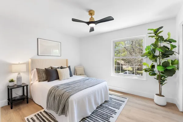 a bed room with a bed and a potted plant