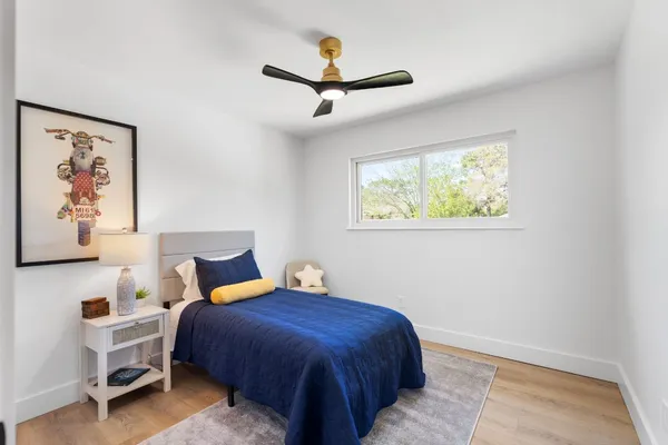 a bedroom with a bed and a painting on the wall