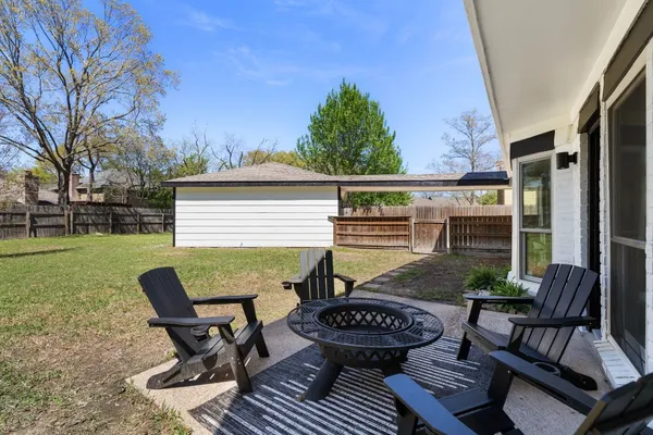 a view of a patio with couches chairs potted plants and a big yard