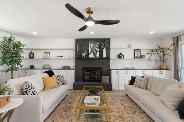 a living room with furniture and a fireplace