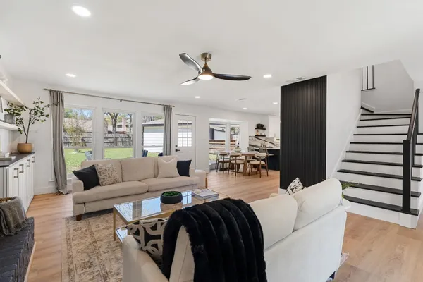 a living room with furniture and wooden floor