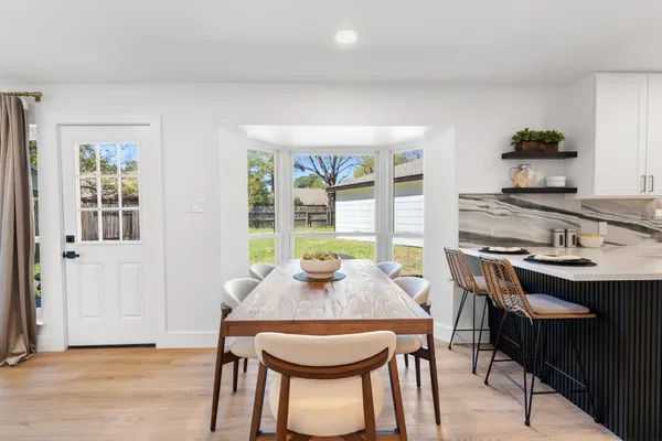 a dining room with furniture and window