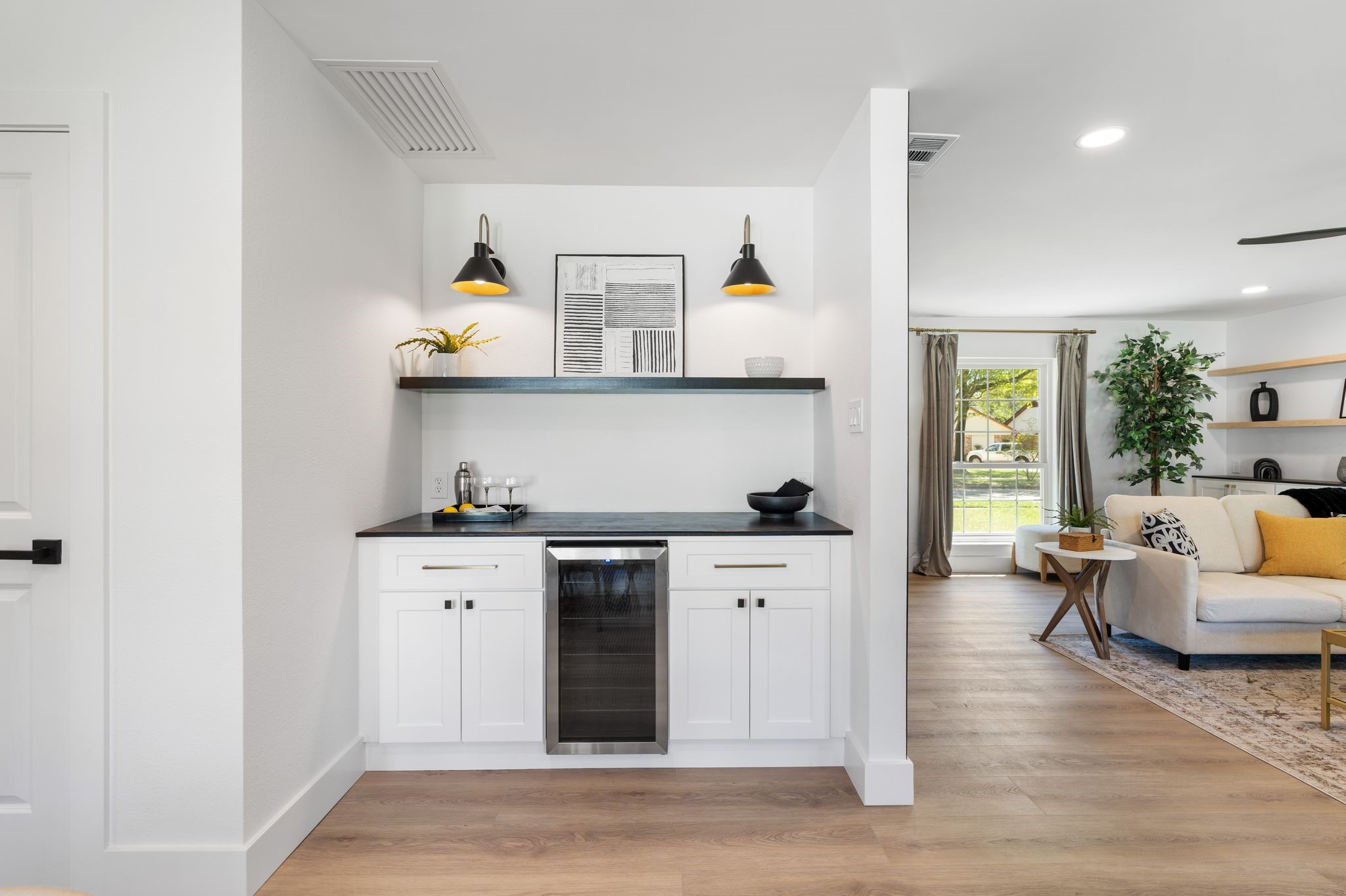 6902 Stoney River Drive Spring, TX 77379 - Photo 9 of 32 Custom-designed bar area complete with a beverage refrigerator, dual sconces, and shelving for the perfect blend of glamour and practicality.
