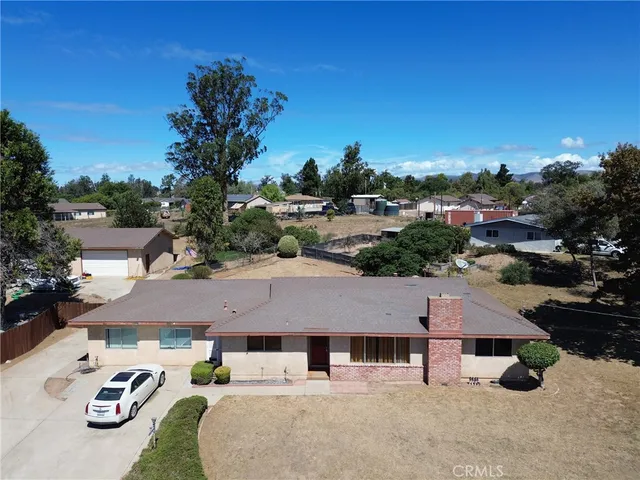 a aerial view of a house with garden space and street view