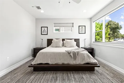 a bedroom with a bed and window