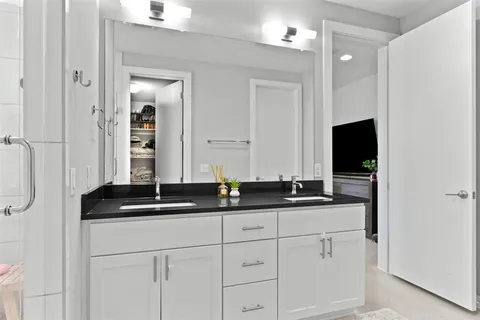 a bathroom with double sink and a mirror