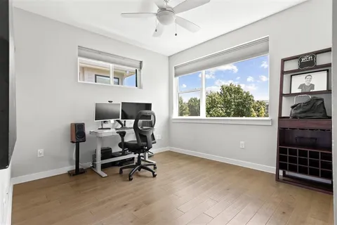 a workspace with wooden floor and a window