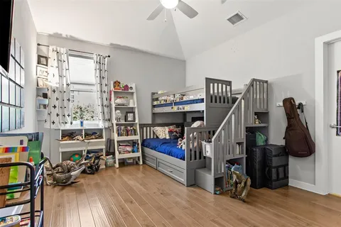 a bedroom with furniture and a book shelf