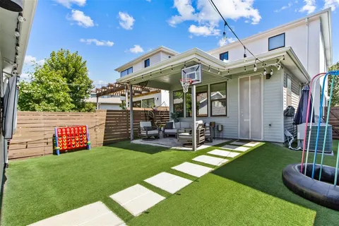a view of a chair and table in backyard of the house