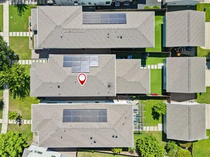an aerial view of a house with yard