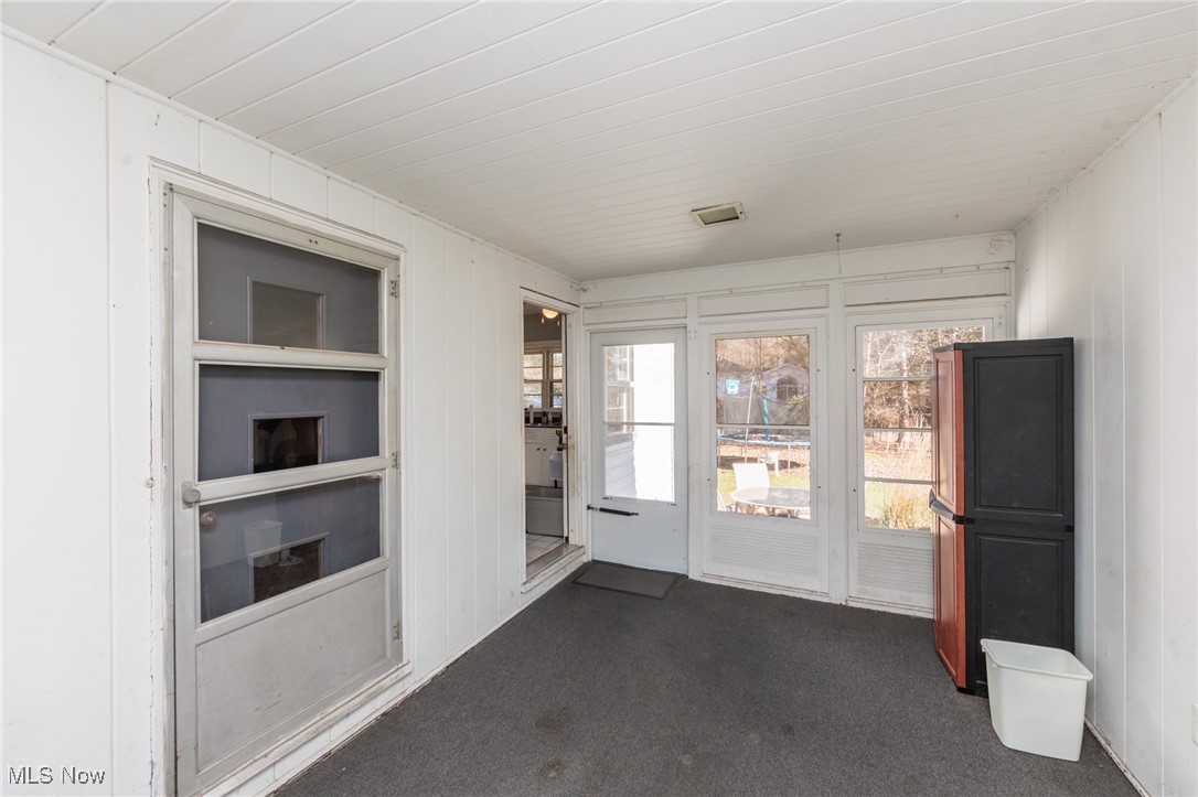 3801 Baird Road Stow, OH 44224 - Photo 13 of 31 Entryway featuring carpet flooring and wooden walls