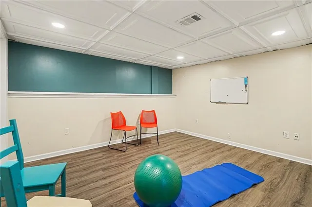 a room with wooden floor and furniture