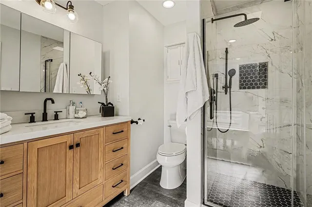 a spacious bathroom with a granite countertop sink mirror and toilet