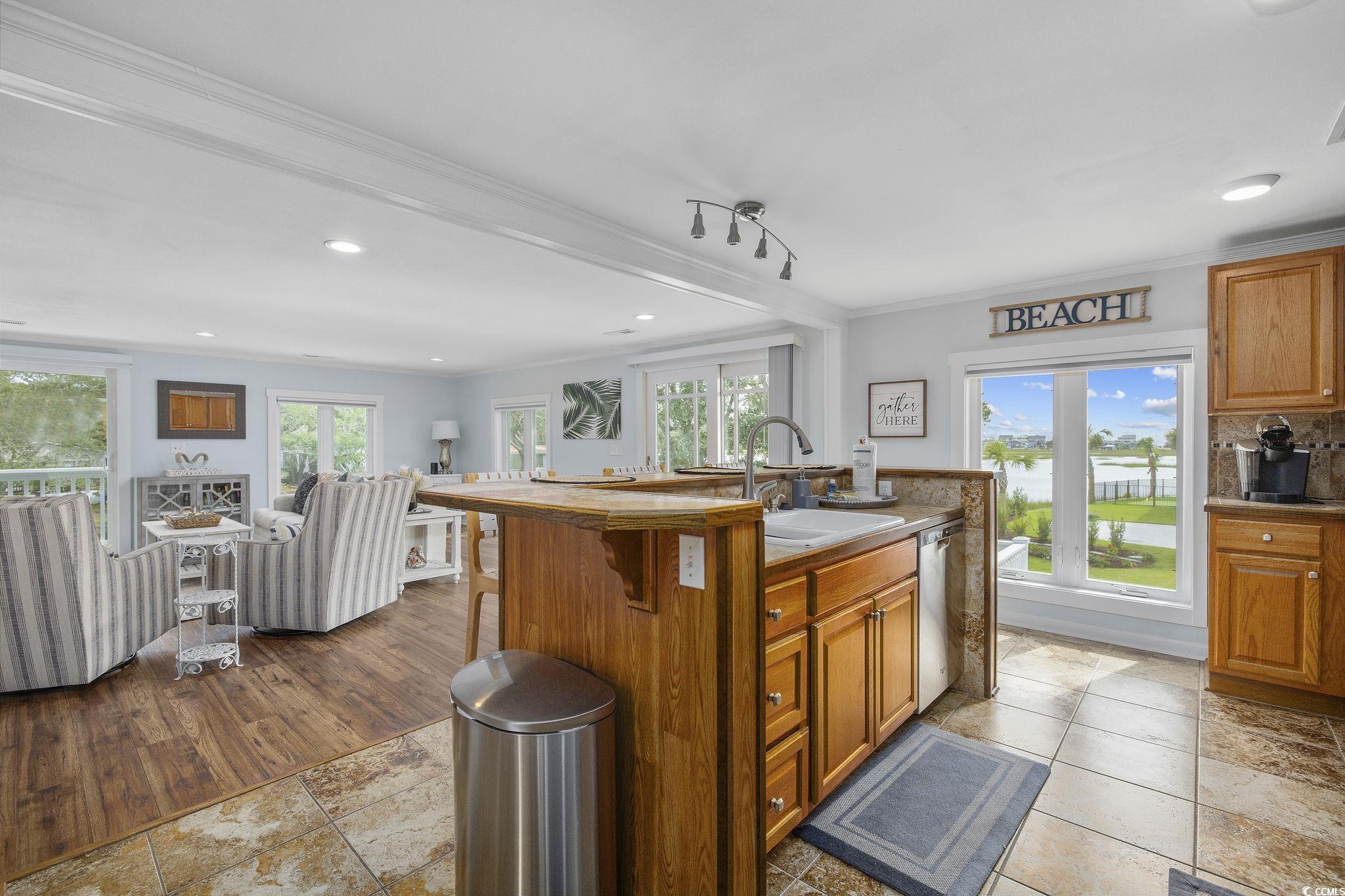 3184 State Rd S-26-816 Murrells Inlet, SC 29576 - Photo 13 of 40 Kitchen with plenty of natural light, ornamental molding, a center island with sink, and sink