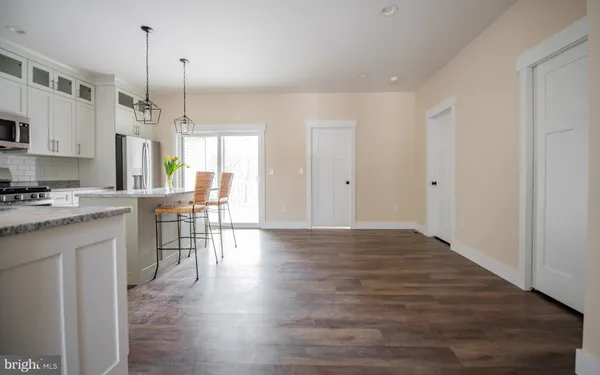 a kitchen with stainless steel appliances granite countertop wooden floors sink and cabinets