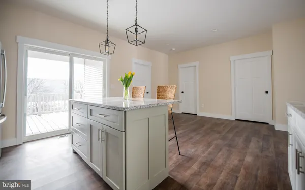 a kitchen with stainless steel appliances granite countertop a stove and a wooden floors