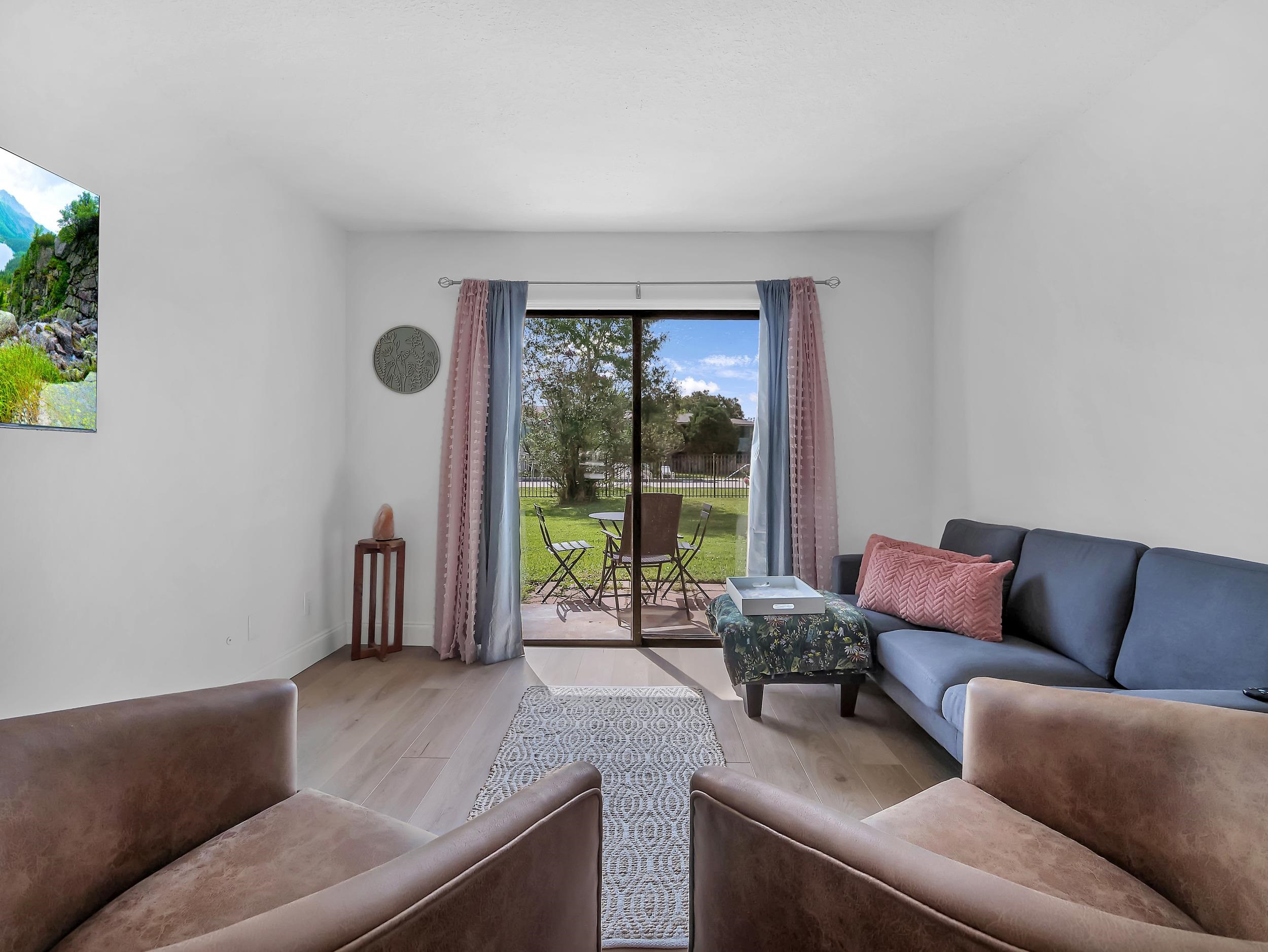650 West Pope Road, Unit 265 St. Augustine, FL 32080 - Photo 11 of 32 a living room with furniture and a floor to ceiling window