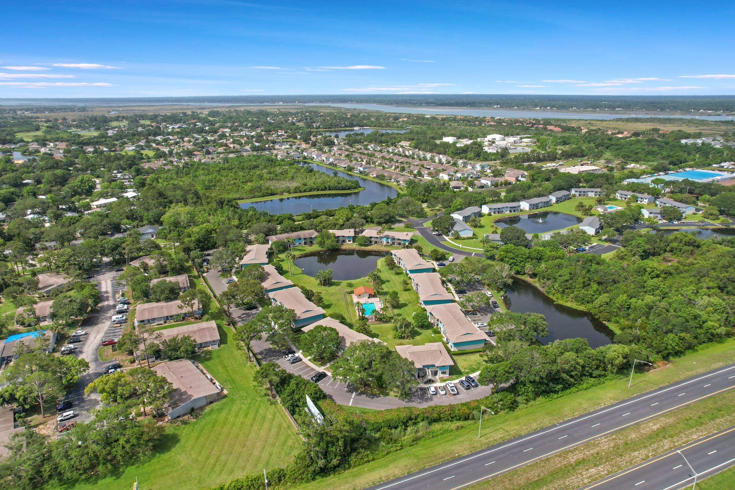 650 West Pope Road, Unit 265 St. Augustine, FL 32080 - Photo 16 of 32 an aerial view of residential houses with outdoor space and trees