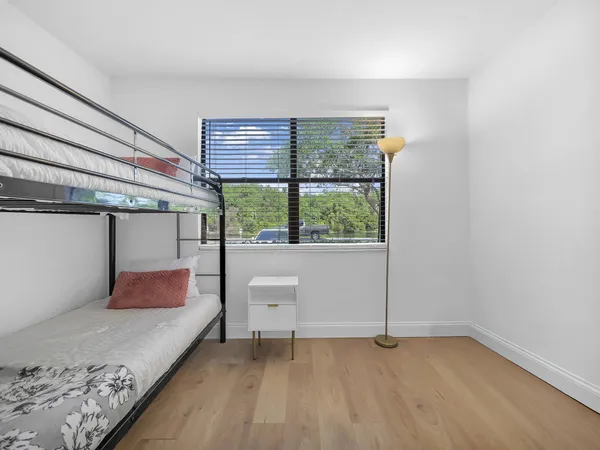 a bedroom with a bed and ceiling fan