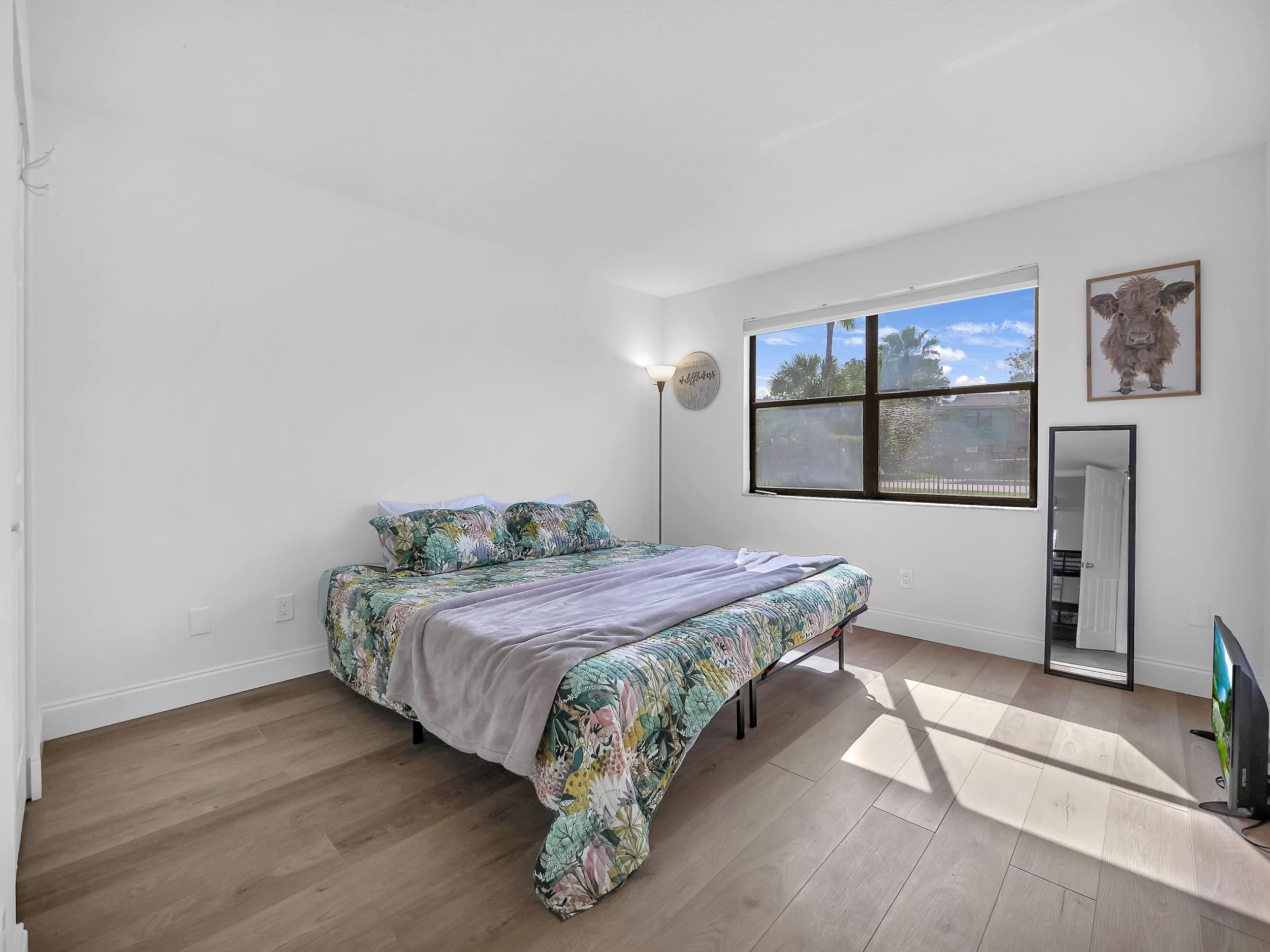 650 West Pope Road, Unit 265 St. Augustine, FL 32080 - Photo 21 of 32 a bedroom with a bed mirror and window