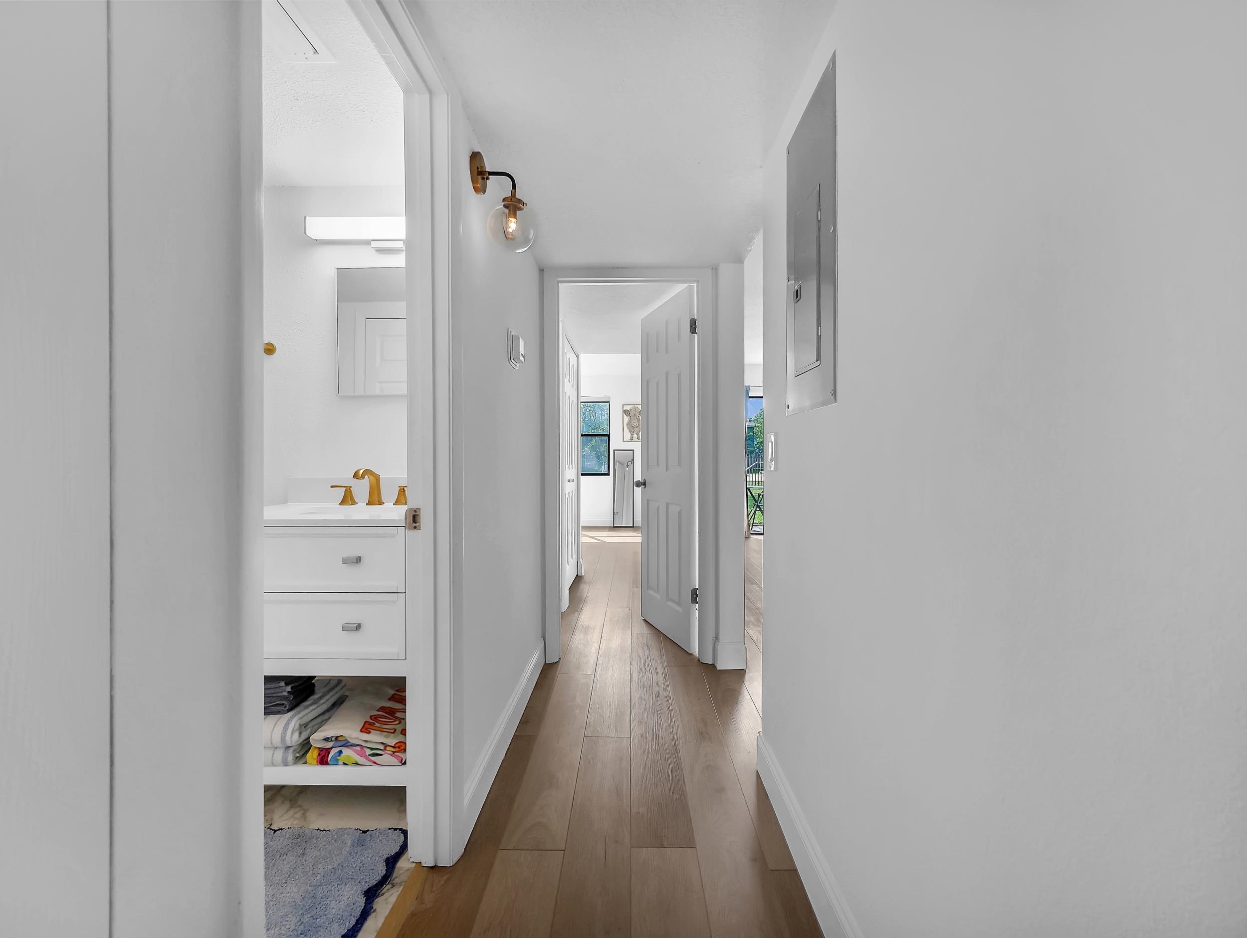 650 West Pope Road, Unit 265 St. Augustine, FL 32080 - Photo 23 of 32 a view of a hallway with wooden floor and a bathroom