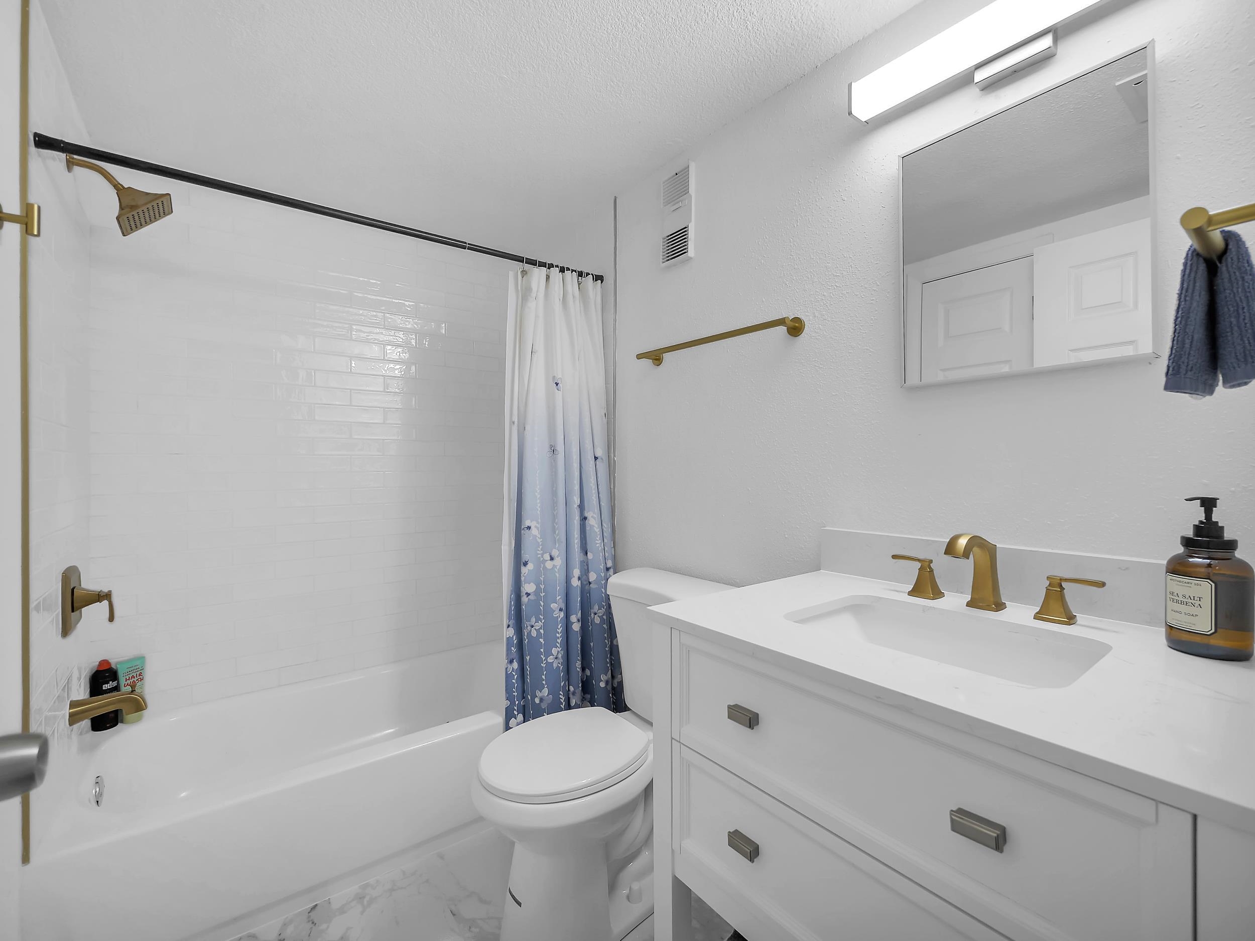 650 West Pope Road, Unit 265 St. Augustine, FL 32080 - Photo 24 of 32 a bathroom with a sink a mirror a toilet and a bathtub