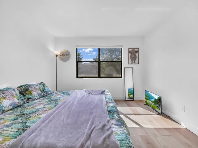 a view of bedroom with a bed and wooden floor