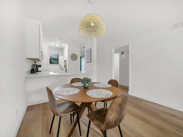 a view of a dining room with furniture and a window