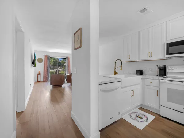 a kitchen with sink cabinets and wooden floor