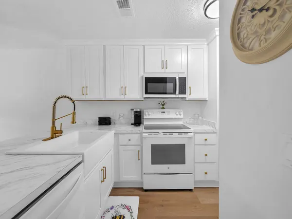 a kitchen with stainless steel appliances granite countertop a sink and a stove