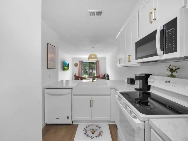 a kitchen with stainless steel appliances a sink stove and cabinets